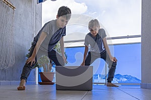 Kids with laptop doing sport exercises at home on balcony. Sport, healhty lifestyle, active leisure, stay at home