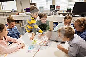 Kids, laptop and invention kit at robotics school