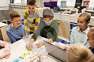 Kids, laptop and invention kit at robotics school