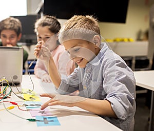 Kids, laptop and invention kit at robotics school