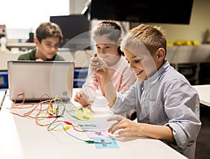 Kids, laptop and invention kit at robotics school