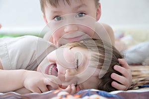 Kids laughing, happy children smiling portrait, playing together siblings, little girl and boy, brother and sister