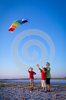 Kids launching the rainbow kite together