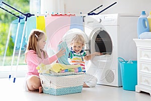 Kids in laundry room with washing machine