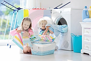 Kids in laundry room with washing machine