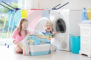 Kids in laundry room with washing machine