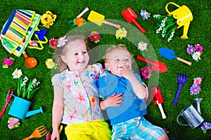 Kids on a lawn with garden tools