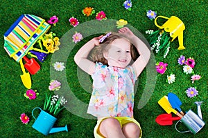 Kids on a lawn with garden tools