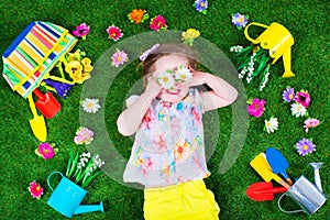 Kids on a lawn with garden tools