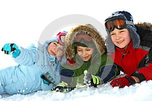 Kids laying in winter snow