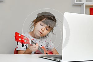 Kids learn music lessons online at home. Homeschooling and distance education for kids. photo