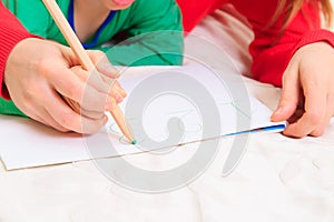 Kids learning - hands of mother and child writing numbers