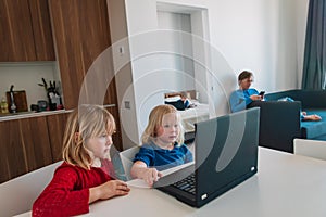 Kids learning remotely with father works from home, family stay idoors