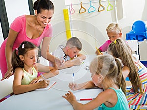 Kids learning to write on lesson in elementary school class