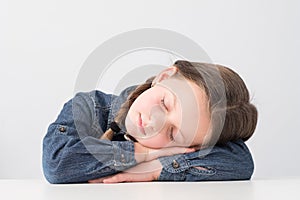 Kids lifestyle tired young girl sleeping table