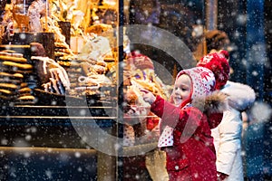 Kids looking at candy and pastry on Christmas market