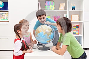 Kids looking at earth globe