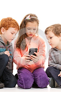 Kids looking at smartphone