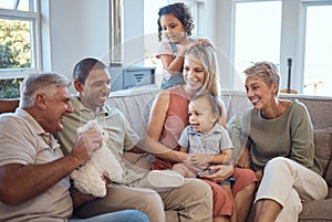 Kids, love and happy family on sofa with baby, laughing and playing in living room in their home. Interracial, happy