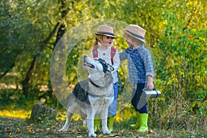 Kids Love story. Happy little couple kids and dog together as friends as love of animals concept. Happy little children