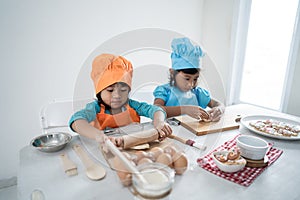 Kids make some dough and cookies together