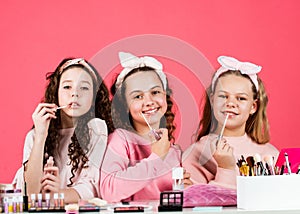 Kids makeup. Beauty and fashion. Hobby and fun. Cosmetics shop. Happy girls doing makeup. Sisters play with cosmetics