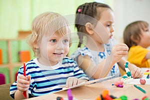 Kids making arts and crafts in day care centre together