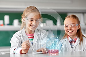 Kids making chemical experiment at school lab