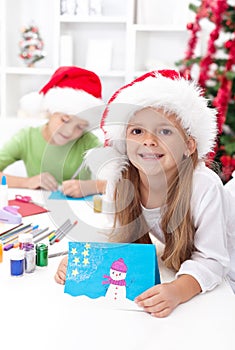 Kids making christmas greeting cards photo