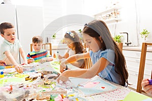 Kids making greeting cards for their moms for the holiday