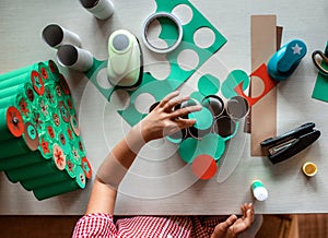 Kids making handmade advent calendar with toilet paper rolls at home. Seasonal activity for kids