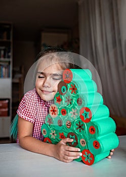 Kids making handmade advent calendar with toilet paper rolls at home. Seasonal activity for kids