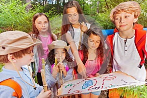 Kids with map on treasure hunt navigation activity
