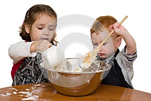 Kids measuring and mixing in kitchen