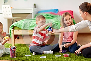 Kids and mother with modelling clay or slimes