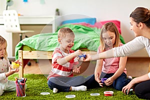 Kids and mother with modelling clay or slimes