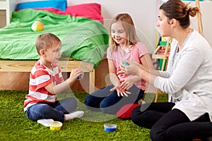 Kids and mother with modelling clay or slimes