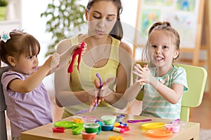 Kids and mother play colorful clay toy