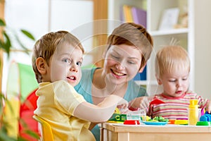 Kids and mother playing colorful clay toy