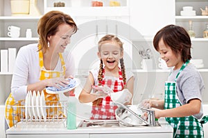 Kids and mother washing the dishes