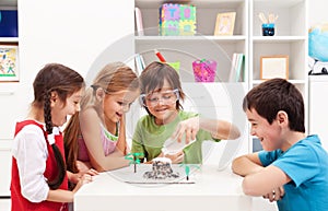 Kids observing a science lab project at home