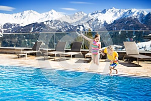 Kids in outdoor swimming pool of Alpine resort