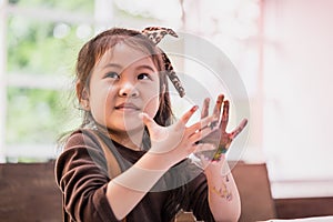 Kids with painted hand in art classroom