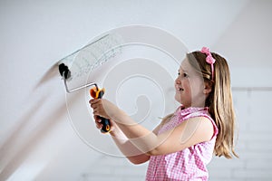 Kids painting attic wall. Home improvement