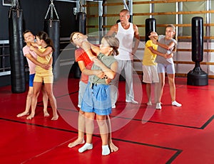 Kids in pairs training elbow strike