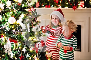 Kids in pajamas under Christmas tree