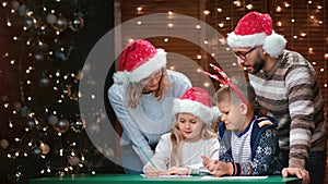 Kids and parents writing list wishes at Christmas eve having positive emotion. 4k Dragon RED camera