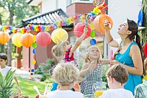Kids party entertainer letting bubbles