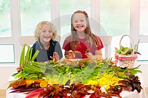 Kids pick colorful autumn leaves for school art