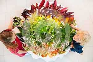 Kids pick colorful autumn leaves for school art